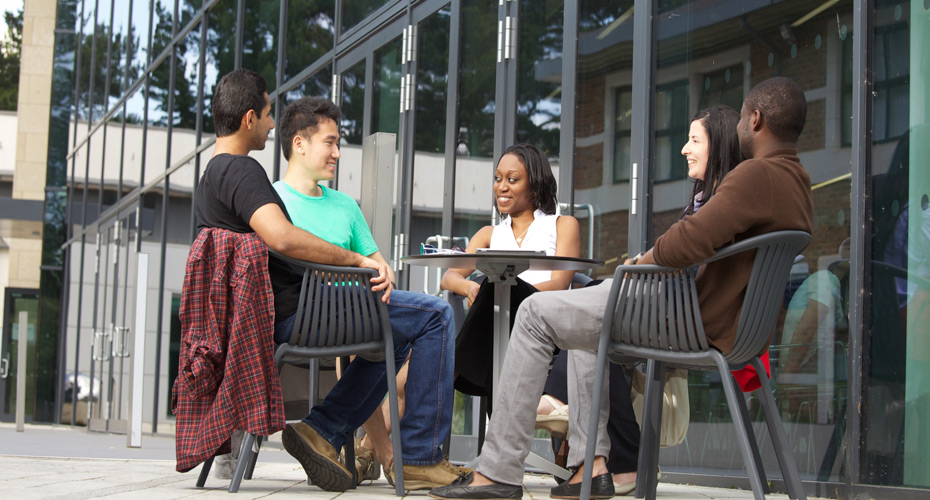 A group of students sitting outside on the campus