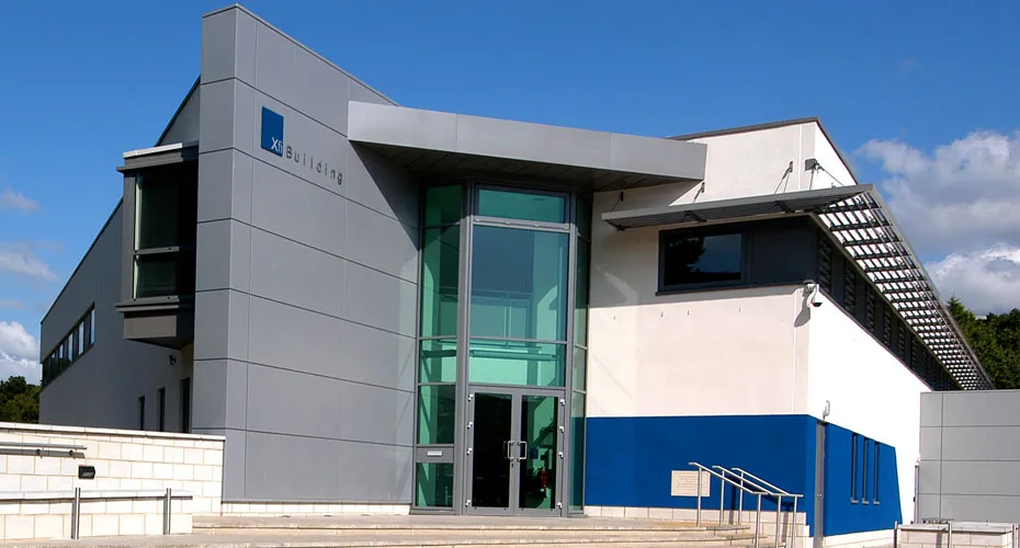 Xifi building at streatham campus featuring a blue door and stairs leading to the entrance.