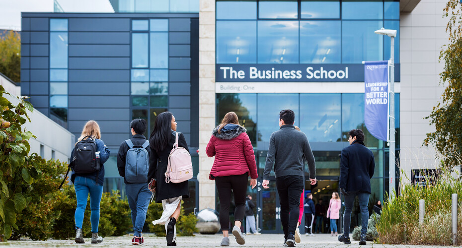 A group of students walking outside the Business School