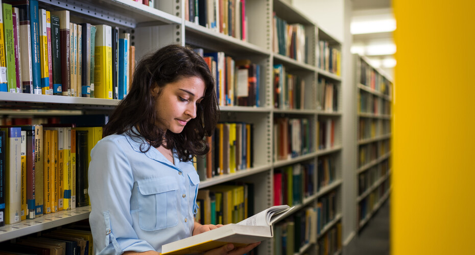 A student finding books in the library on Streatham campus