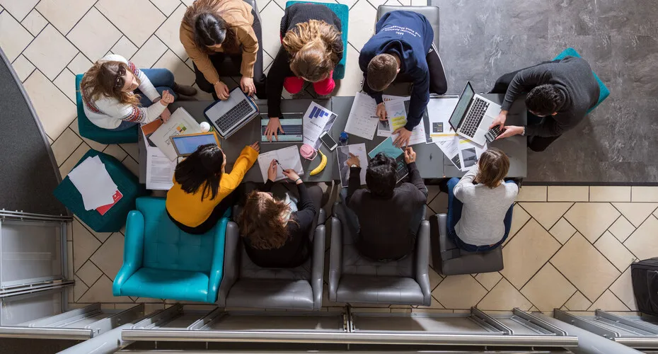 A group of students studying together in the business school.