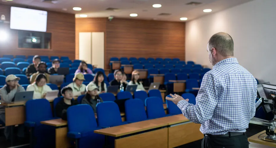 business and management lecture at business school with students and presenter in modern classroom.