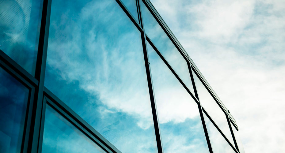 Windows on a building reflecting the sky