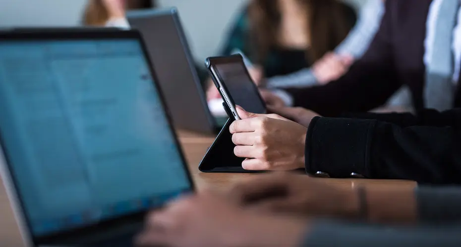 Economics students working on tablet devices.